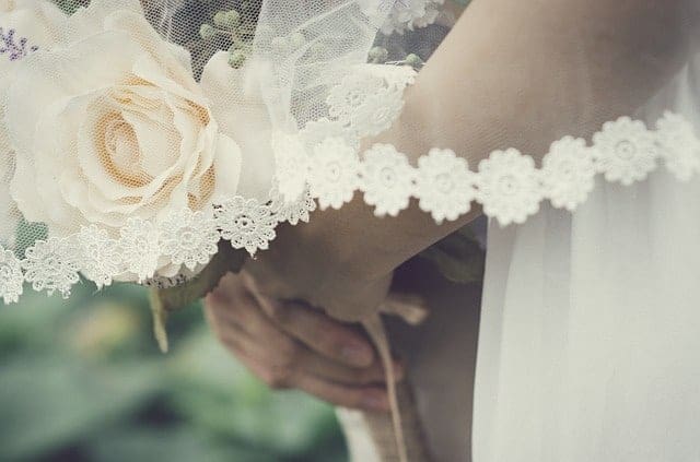 A brides hands and bouquet