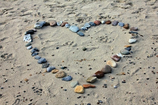 A heart shape made from stones on the beach
