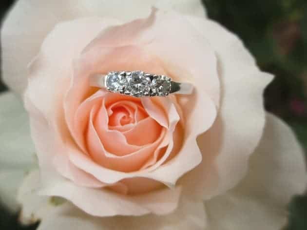 An engagement ring placed on a flower
